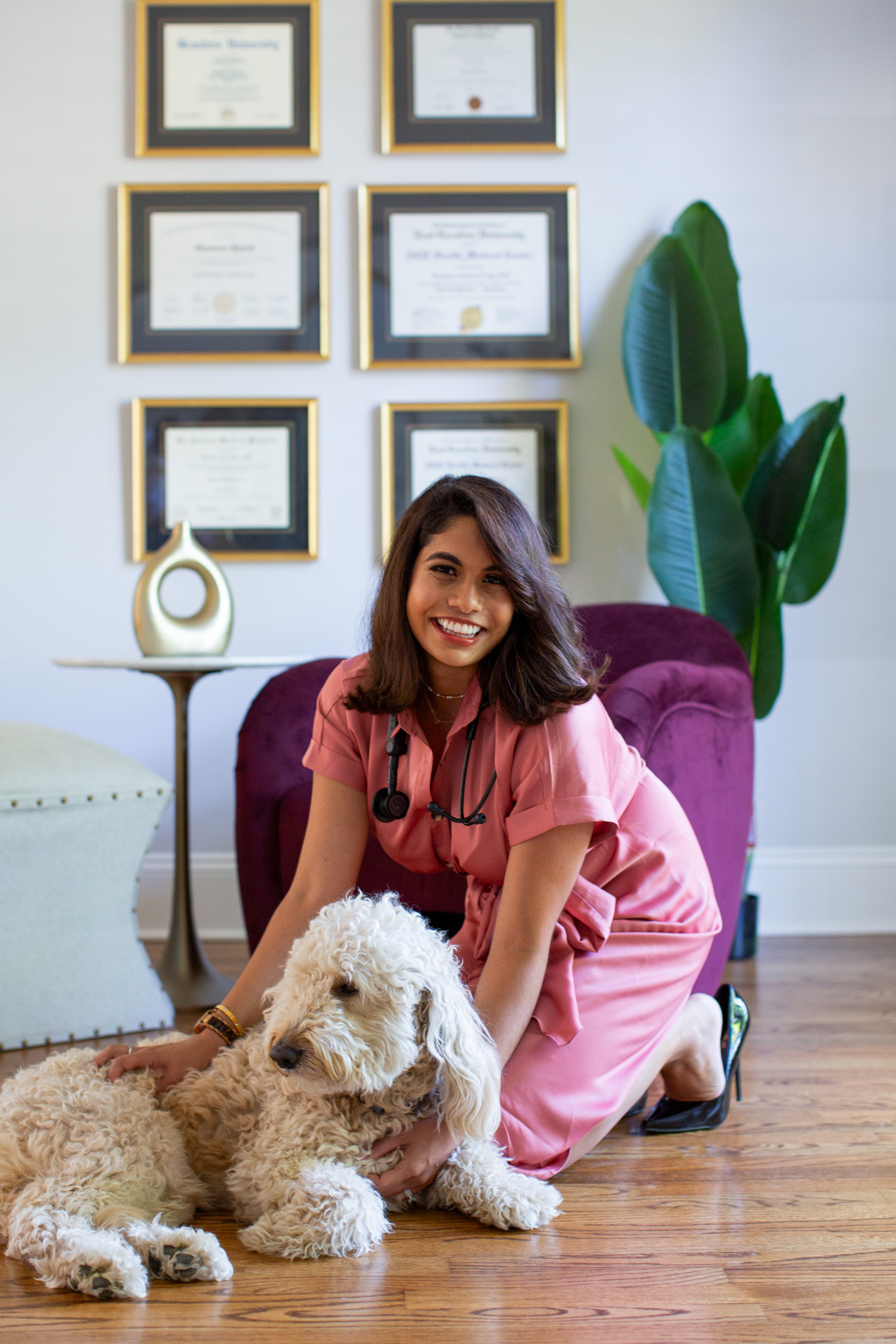 Dr. Shaoleen Daly smiling beside her dog in her Lake Norman office